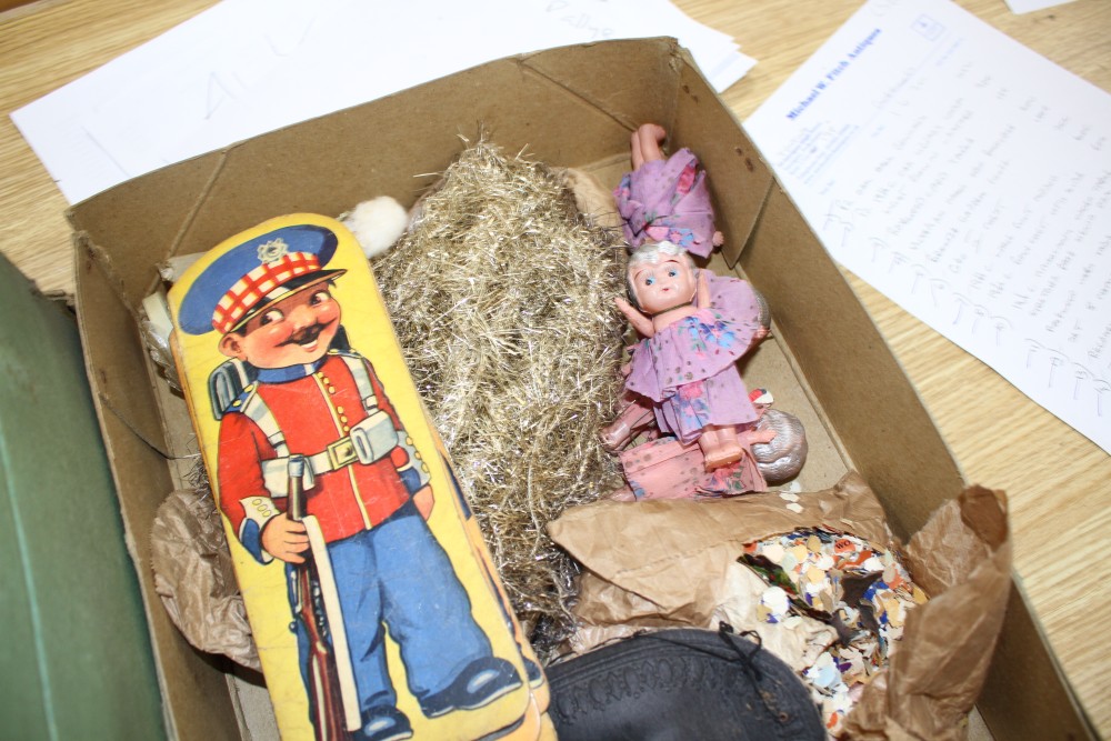 A collection of assorted curios, mostly vintage Christmas decorations but including masks and paper cut-outs